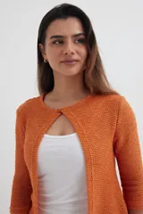 Cardigan tejido color verde oliva con mangas 3/4 y botón superior.