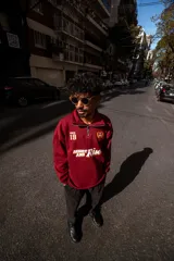 Buzo de algodón color bordó, estilo universitario, con cierre medio frontal y cuello alto. Estampado frontal con el texto "Since 19" y un ancla con laureles en amarillo y blanco.