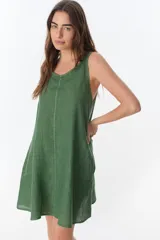 Vestido verde oliva de lino, corte recto, sin mangas y con bolsillos laterales.