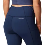 Calza deportiva negra de tiro alto, confeccionada en poliéster reciclado y elastano, con tecnología Omni-Wick™ y bolsillo lateral en la pierna.