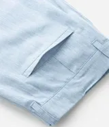 Bermuda de hombre en lino color gris claro, de corte recto, con textura discreta, bolsillos laterales y cierre frontal con botón y cremallera.