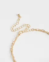 Collar dorado de doble cadena, una con dijes de perlas y ojo turco rojo, y otra con dijes de mano de Fátima y monedas.