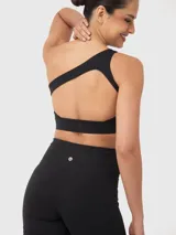 Top deportivo negro de un hombro con tirantes elásticos en la espalda y almohadillas removibles.