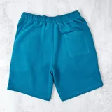 Short color verde petróleo de algodón fino, con cintura elástica y cordón ajustable.