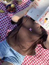 Remera chocolate de corte cuadrado con logo bordado en color rosa.