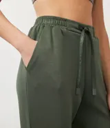 Pantalón jogger deportivo color verde militar, con cintura elástica, cordón ajustable y bolsillos laterales. Confeccionado en modal, con puños ajustados.