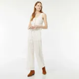 Blusa blanca sin mangas con bordado inglés, escote en V y lazos ajustables en el frente.