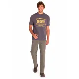 Remera de manga corta color gris jaspeado con un gráfico frontal en amarillo que celebra el centenario de Caterpillar (1925-2025).