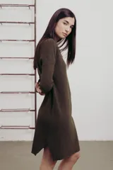 Vestido a la rodilla color bordó, tejido en punto suave, con escote en V, mangas largas y aberturas laterales.