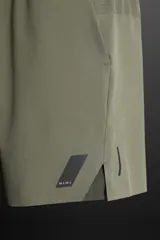 Shorts deportivos color gris oscuro confeccionados en tejido técnico ligero y elástico con forro interior, cintura elástica ajustable con cordón, bolsillos laterales, bolsillo de seguridad en espalda con cierre de cremallera, bajo con aberturas laterales y detalle de logo estampado en pernera.