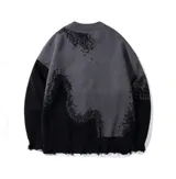 Sweater gris con detalles en negro, con cuello redondo y mangas largas.