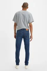 Pantalones jeans de corte skinny en azul oscuro, con apertura estrecha en la pierna y tejido elástico.