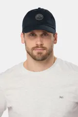 Gorro de lona azul marino con visera curva y parche circular con logo bordado en el frente.