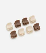 Set de ocho mini pinzas para el pelo, cuatro en color crema y cuatro en color marrón chocolate.