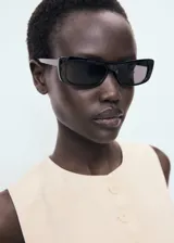 Chaleco color crema con cuello redondo y cierre frontal con botones.