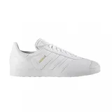 Championes Adidas Gazelle de cuero blanco con las tres tiras laterales y el logo en dorado.