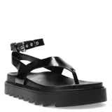 Sandalia negra con pulsera al tobillo y plataforma con suela dentada.