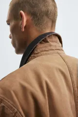 Cazadora relaxed fit de algodón acolchado, color celeste con efecto lavado. Tiene cuello solapa, manga larga con puño abotonado, bolsillos con cremallera en pecho y cadera, y cierre frontal con cremallera.