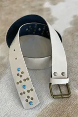 Cinturón marrón de cuero vacuno con hebilla metálica y apliques de tachas y turquesas.