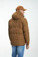 Campera puffer color marrón con capucha no desmontable, cierre frontal con cremallera y botones a presión, bolsillos laterales y bolsillo en el pecho con cierre.