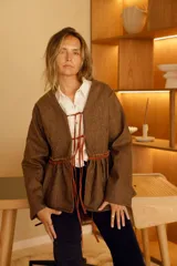 Chaqueta marrón de lana con forro de algodón y tiras de cuero. Diseño con cuello en V y corte a la cintura.