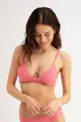 Top de bikini triangular color rosa con textura acanalada y tirantes finos.
