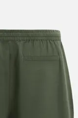 Pantalón azul marino de corte amplio, confeccionado en tejido de mezcla de algodón y lino. Cuenta con cintura elástica ajustable con cordón, bolsillos frontales y bolsillos traseros de vivo.