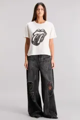 Remera blanca de algodón con cuello redondo y mangas cortas. Estampado frontal con el logo de la lengua de los Rolling Stones en color negro.