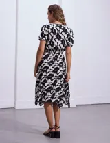 Vestido midi estampado con flores color celeste y beige, escote cruzado, mangas cortas con puños elastizados, cintura elastizada con lazo de ajuste.