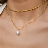 Cadena dorada fina con eslabones tipo fígaro.