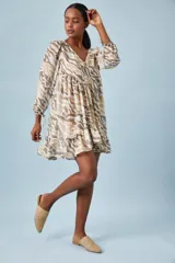 Vestido corto de gasa con estampado camuflado, mangas largas tipo globo y detalles metálicos en las tiras.