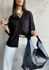 Camisa negra de manga larga con bordado floral.