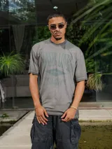 Remera de jersey con efecto teñido y corte holgado. Presenta una estampa frontal con el texto 'Sunset Lover' y 'You're my last sunburn' en color verde.