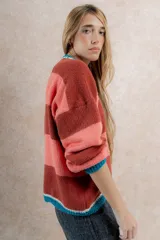 Sweater tejido de punto a rayas horizontales color ladrillo y salmón, con cuello redondo y mangas largas abullonadas con puño.