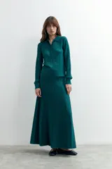 Falda larga de tejido lurex color verde, con textura acanalada y caída fluida.