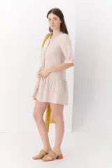 Vestido blanco de lino con cuello mao, manga corta y corte evasé.