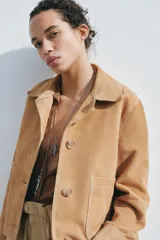 Chaqueta de mujer realizada en piel de ante color beige. Tiene cuello solapa, manga larga, bolsillos de plastrón en delantero y cierre frontal con botones.