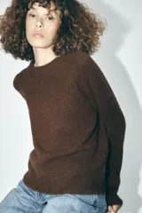 Sweater de punto color borgoña, de corte recto, cuello redondo y manga larga.