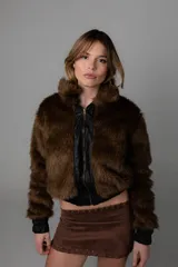 Campera corta marrón de pelo sintético con forro interior y puños de cuero sintético.