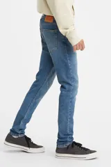 Pantalón de jean de corte skinny, color azul claro, con tiro medio y cinco bolsillos.