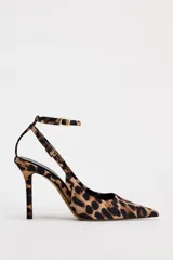Zapato destalonado de tacón alto con estampado animal, acabado en punta y pulsera al tobillo con cierre de hebilla.