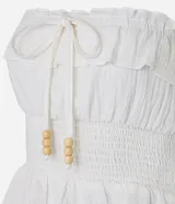 Blusa sin breteles color blanco, confeccionada en crepé con textura crinkle y lastex en la cintura.