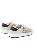 Zapatillas bajas color beige con estampado animal print en tonos marrones y negros.