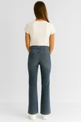 Pantalón de jean negro, de corte flare y tiro medio, con bolsillos delanteros y traseros.