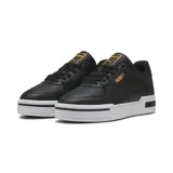 Championes urbanos de cuero negro con detalles dorados, suela blanca y logo de Puma en dorado.