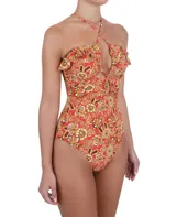 Traje de baño entero con estampado floral en tonos naranja, marrón y amarillo. Presenta escote pronunciado con tiras cruzadas y volados en los hombros.