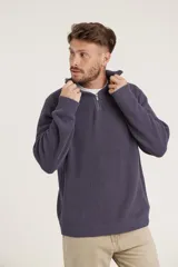 Sweater de punto color crema con cuello alto y cierre de cremallera parcial. Diseño de corte holgado y mangas largas.