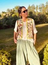 Chaleco estampado con bordados coloridos, confeccionado en tela con cuerpo y diseño elegante.