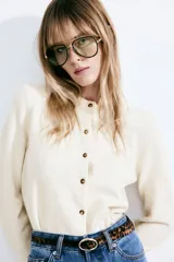 Cárdigan color crema de punto suave con lana en la trama. Modelo con cuello redondo ribeteado acanalado, cierre frontal con botones, remate acanalado en puños y bajo.