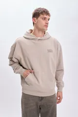 Canguro beige con capucha y estampa de Yoda con sable láser en la espalda.